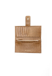 Brown crocodile-patterned wallet on a white background